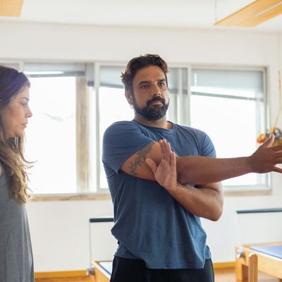 A man stretching his back after a workout session.
