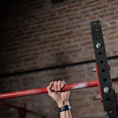 Close-up on hands gripping the floor during a plank exercise.