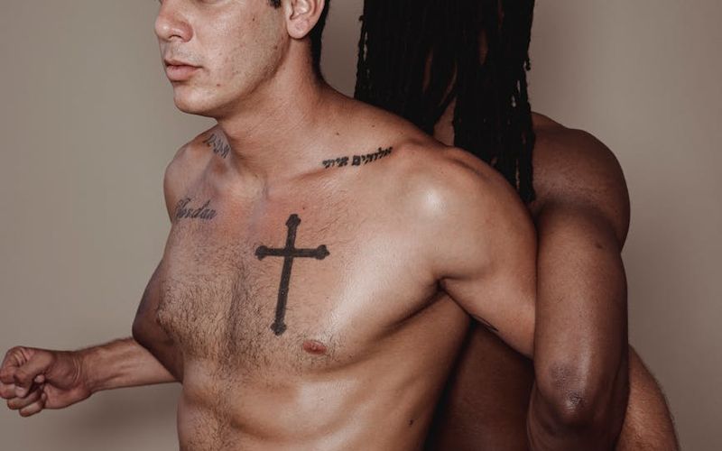 Man performing a controlled bodyweight exercise in a minimalist gym setting.